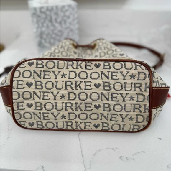 Dooney & Bourke Ivory and Brown Bucket Bag with Dachshund Leather Charm